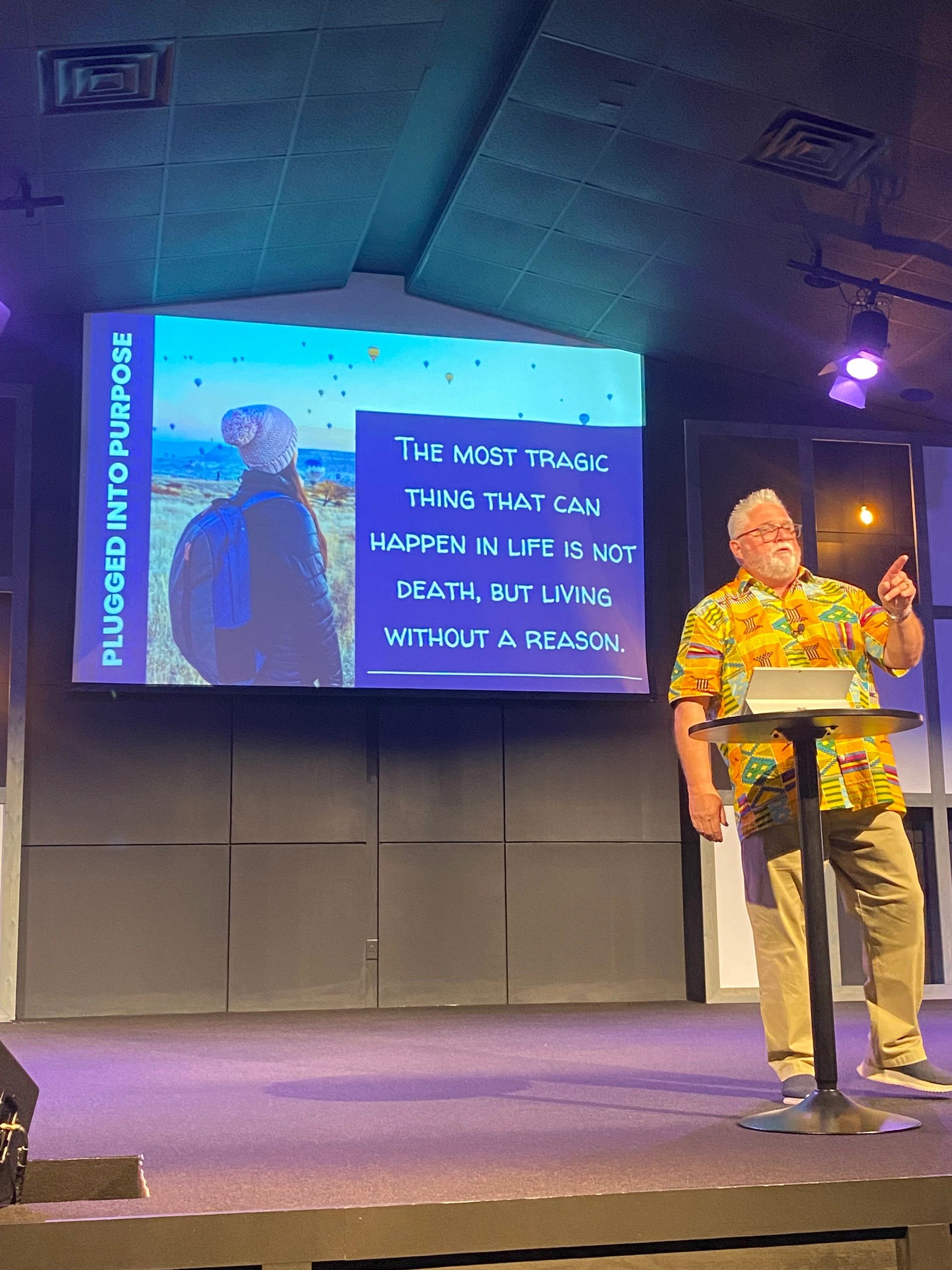 Mike Campbell preaching on stage at a teaching session